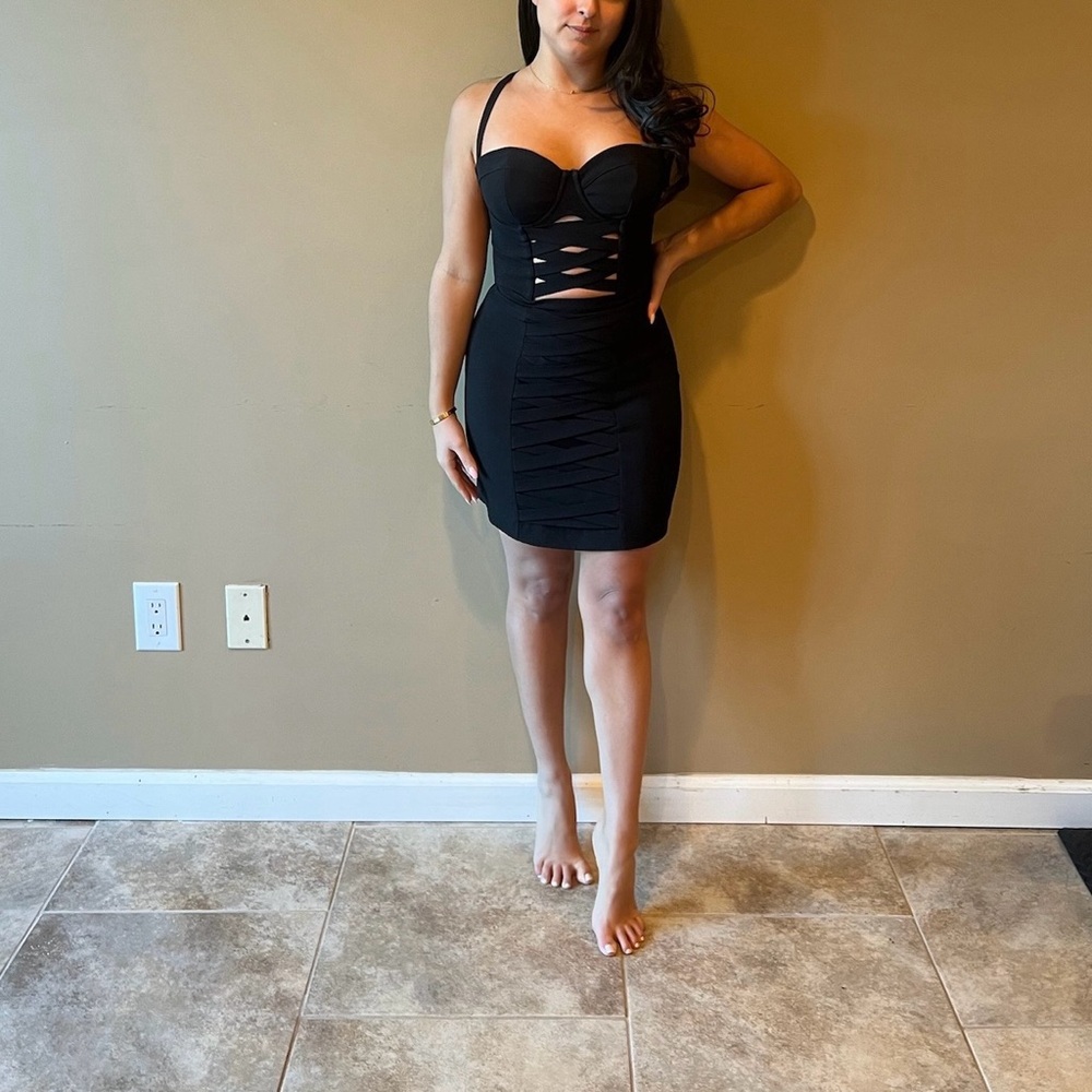 Black mini BEBE dress with center cut outs.